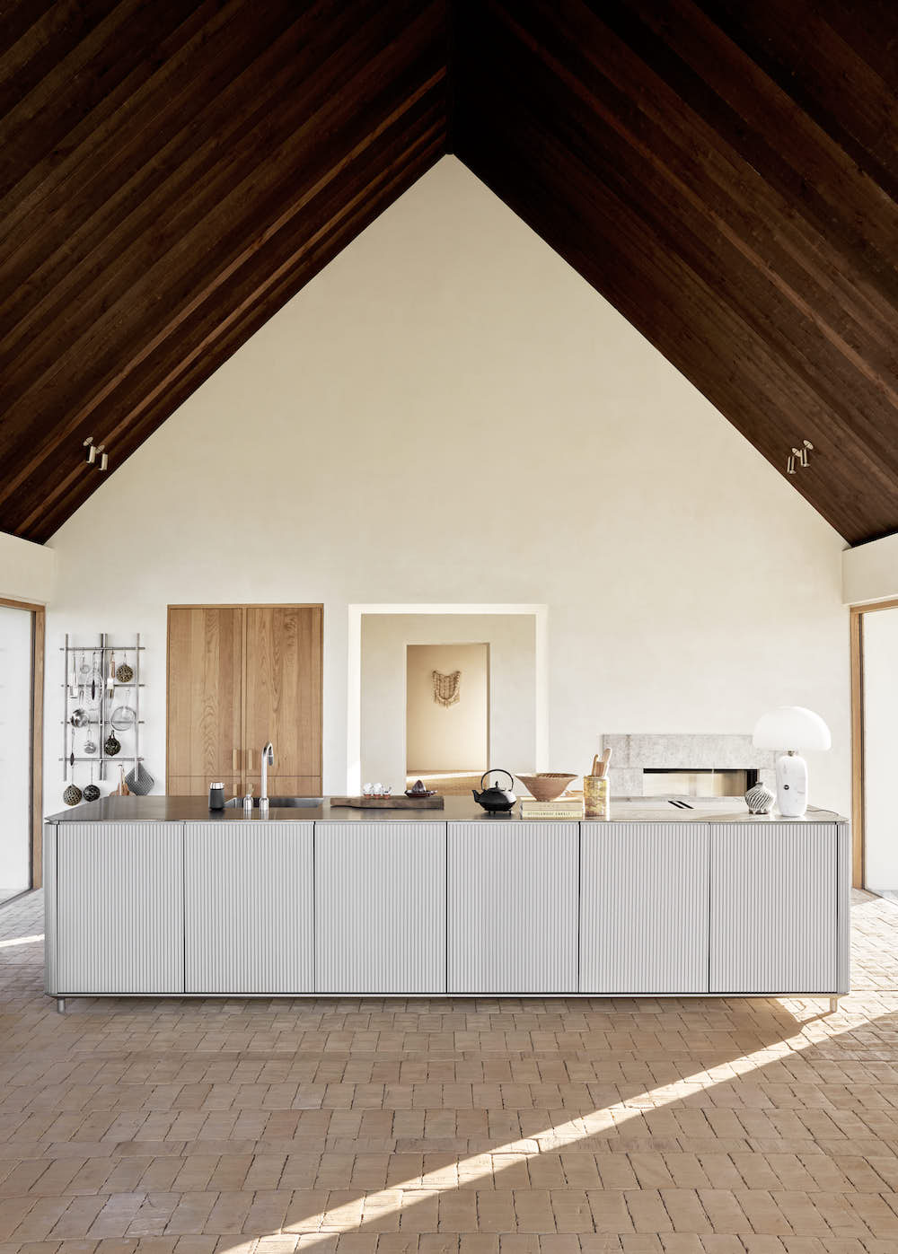 An aluminum freestanding kitchen with a wooden ceiling.