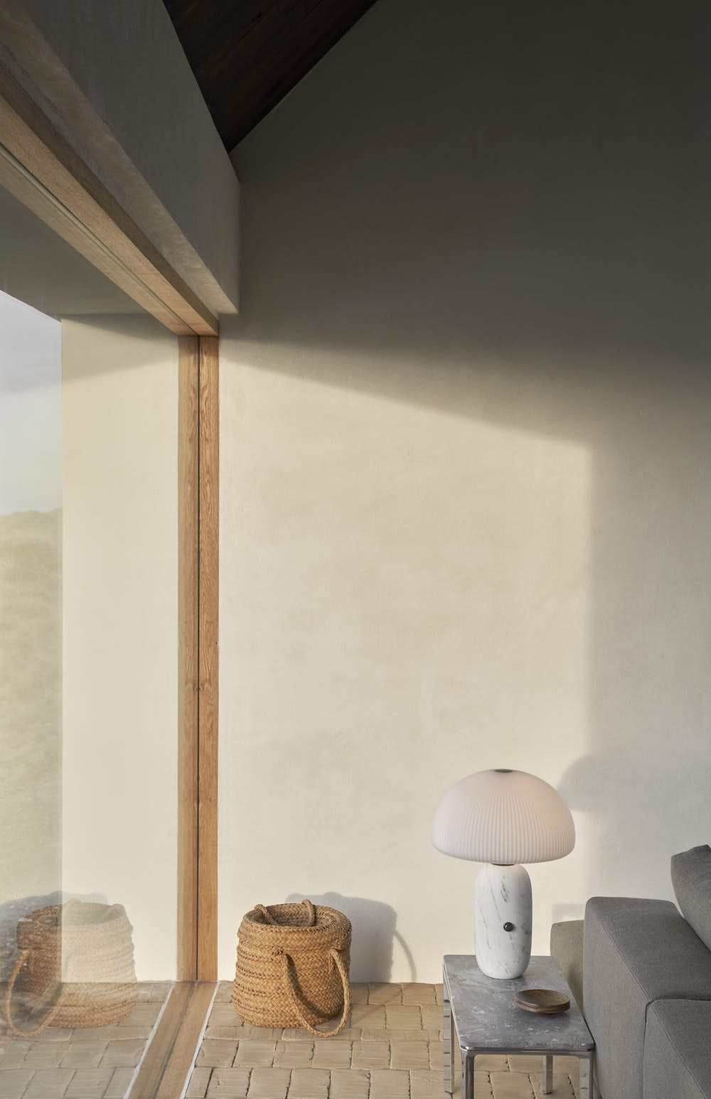 Corner living room with sidetable and table lamp.