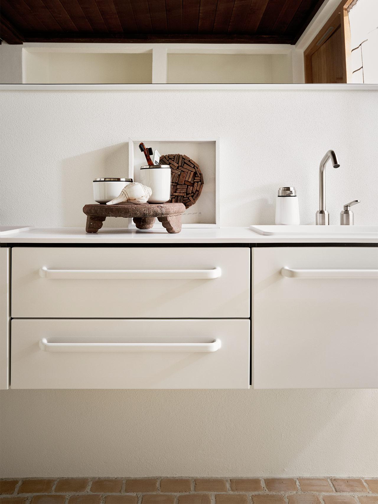 White bathroom vanity with decorations.